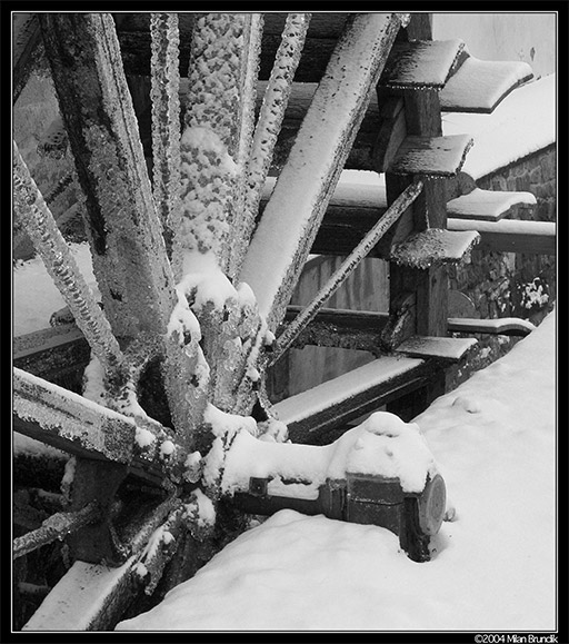 Snowy watermill wheel on Certovka